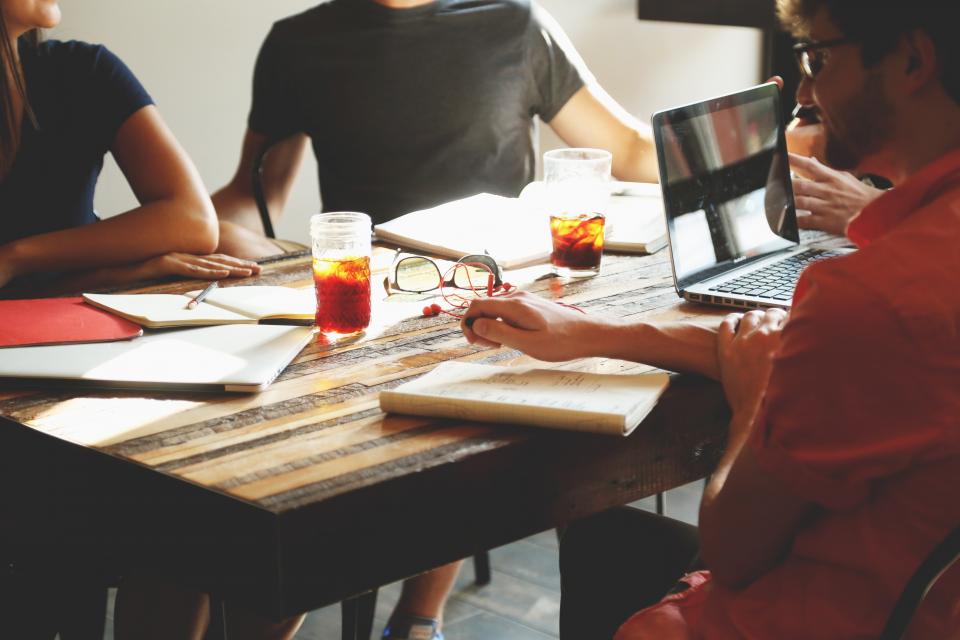 Small team talking around a work table
