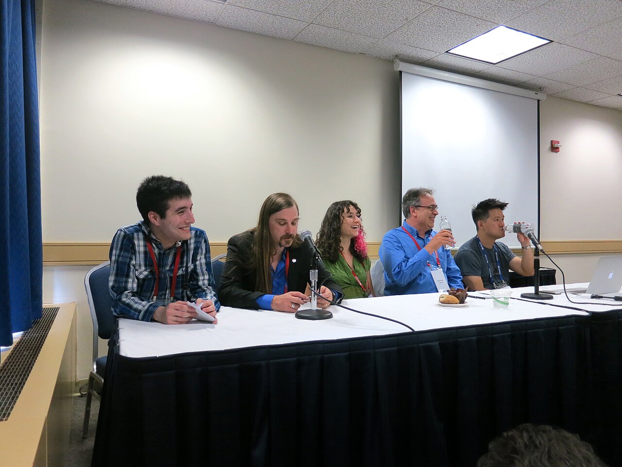 Speakers seated together during a conference panel
